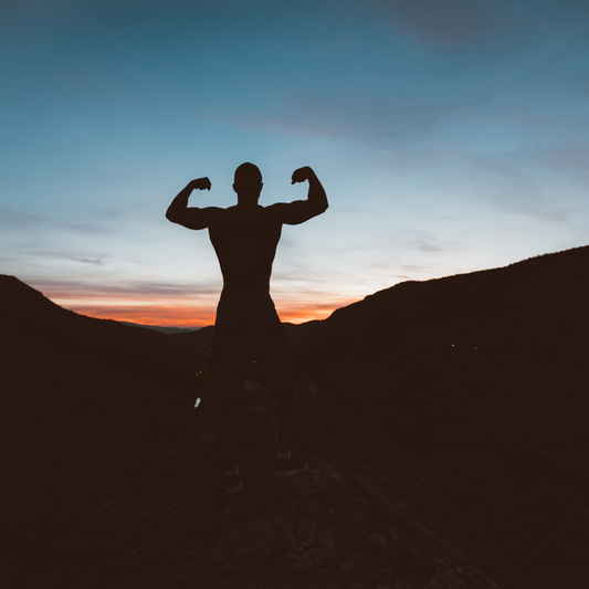 man flexing at sunset